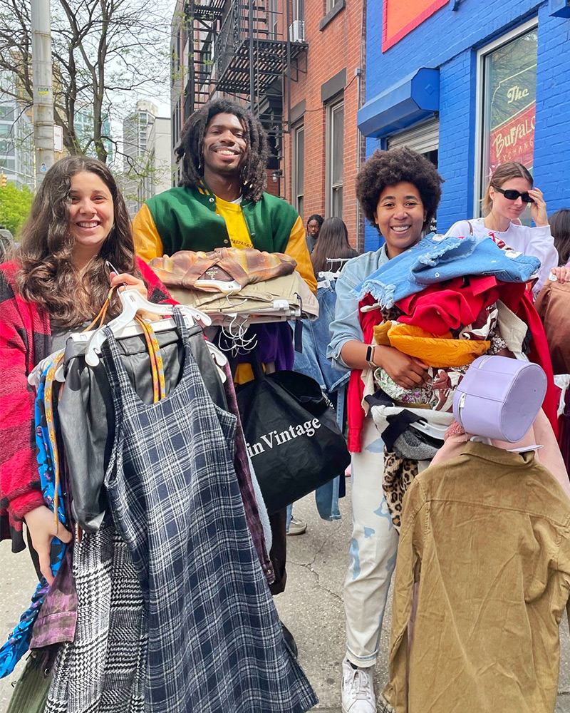 Group of $1 sale customers with piles of clothes