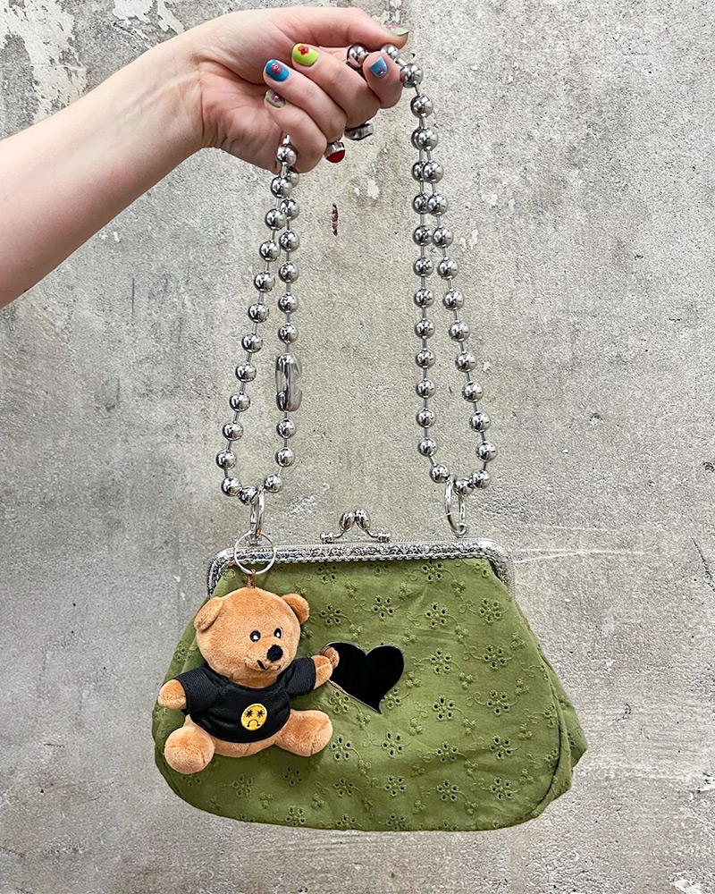 Small olive green handbags with a plush teddy bear charm