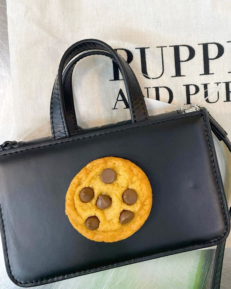 A leather handbag with a faux chocolate cookie by Puppets and Puppets