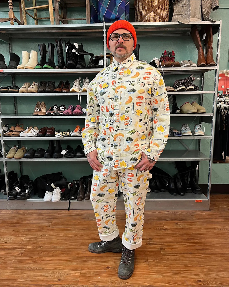 A man wearing a two piece casual suit illustrated with seafood