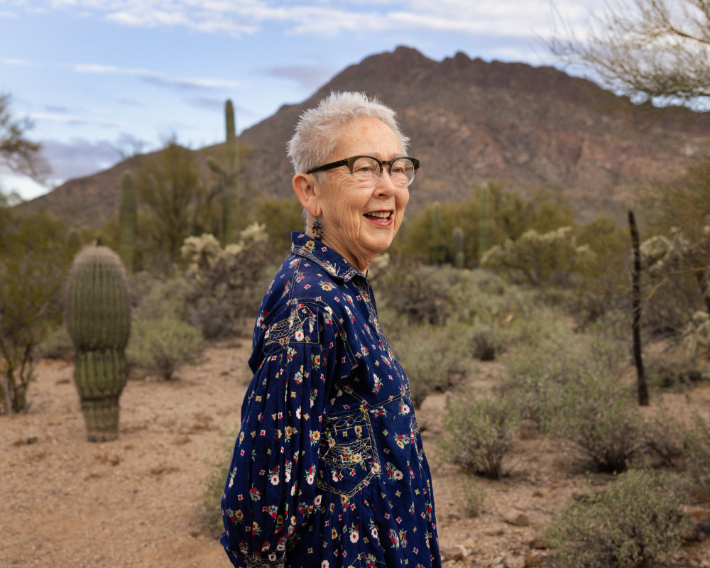 portrait of Buffalo Exchange founder Kerstin Block standing in desert mountain landscape
