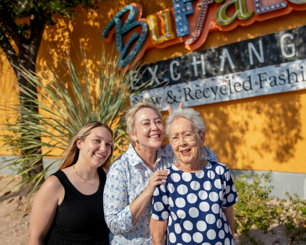 Three generations of the Block family pose for photo near Buffalo Exchange Tucson store sign